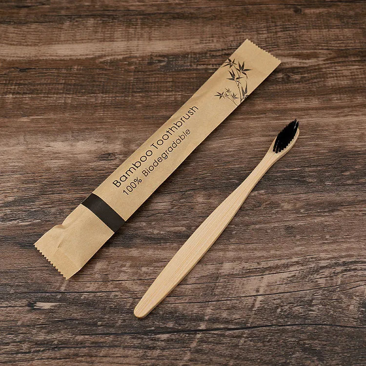 Set of ten bamboo toothbrushes with charcoal bristles in assorted colours on a plain background
