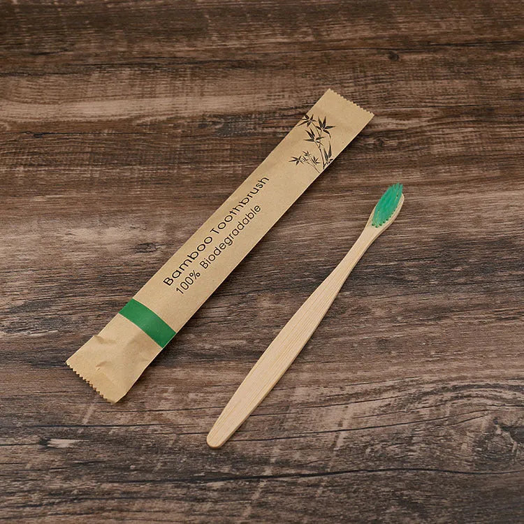 Set of ten bamboo toothbrushes with charcoal bristles in assorted colours on a plain background