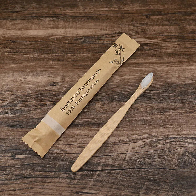 Set of ten bamboo toothbrushes with charcoal bristles in assorted colours on a plain background