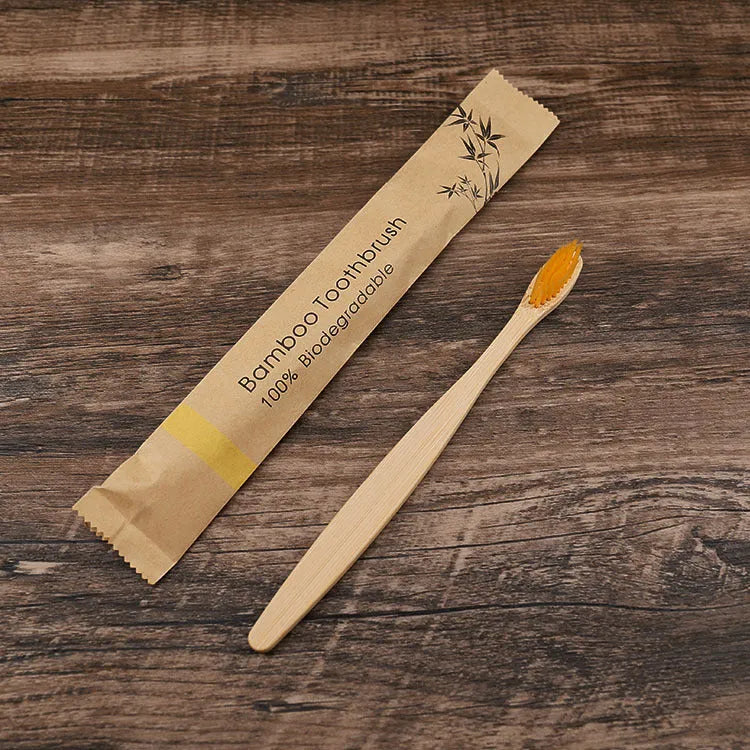Set of ten bamboo toothbrushes with charcoal bristles in assorted colours on a plain background