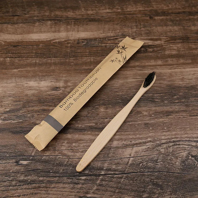 Set of ten bamboo toothbrushes with charcoal bristles in assorted colours on a plain background