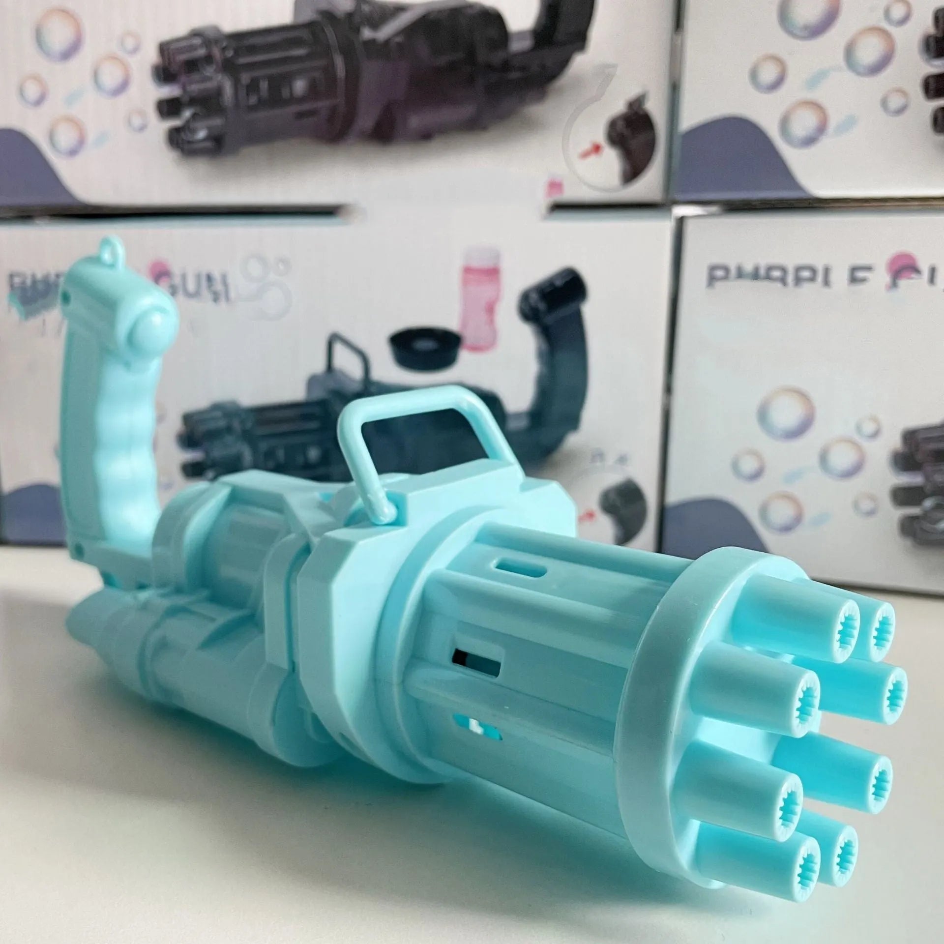 Kids pink bubble machine gun toy with leaf blower design on green grass