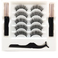 Magnetic eyeliner and five pairs of reusable false mink eyelashes set on white background.