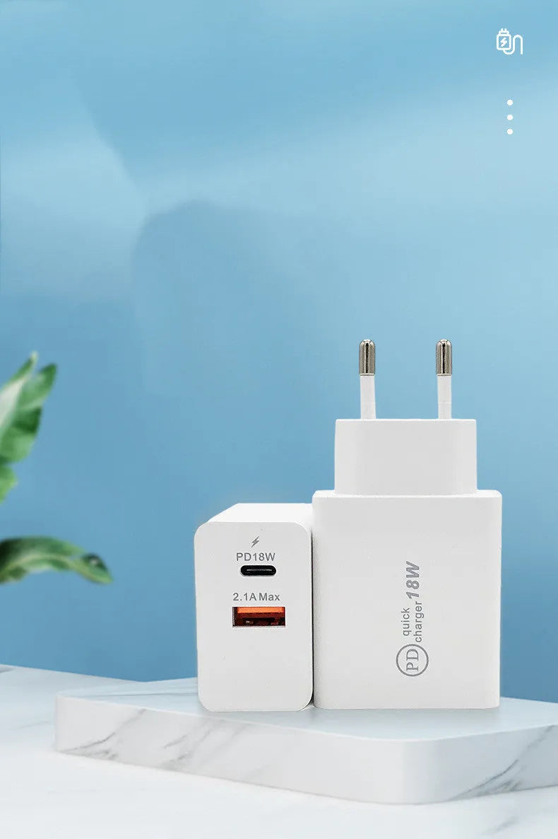 Black 18W USB-C fast wall charger with US plug next to a smartphone