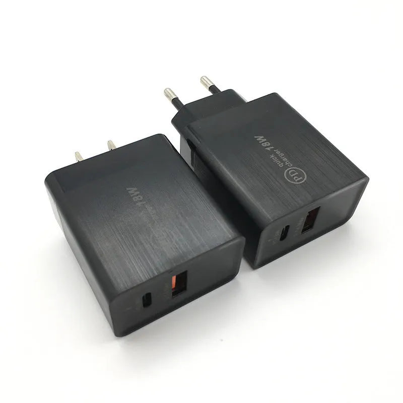 Black 18W USB-C fast wall charger with US plug next to a smartphone