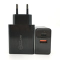 Black 18W USB-C fast wall charger with US plug next to a smartphone