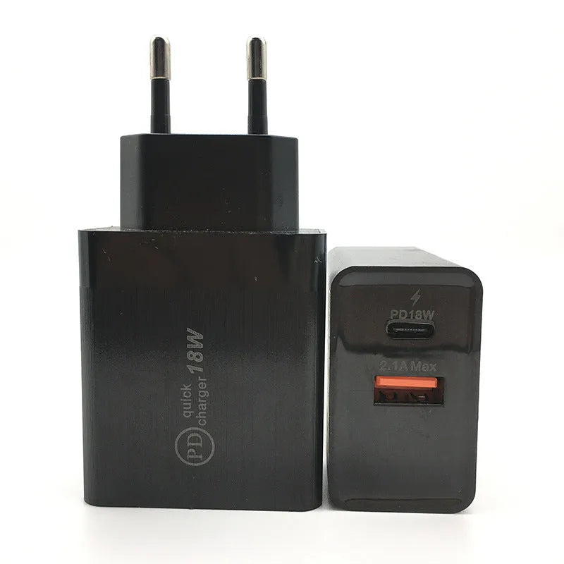 Black 18W USB-C fast wall charger with US plug next to a smartphone