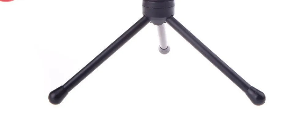 Black wired desktop microphone with a metal holder clip on a desk.