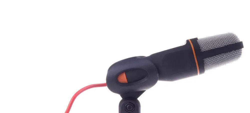 Black wired desktop microphone with a metal holder clip on a desk.