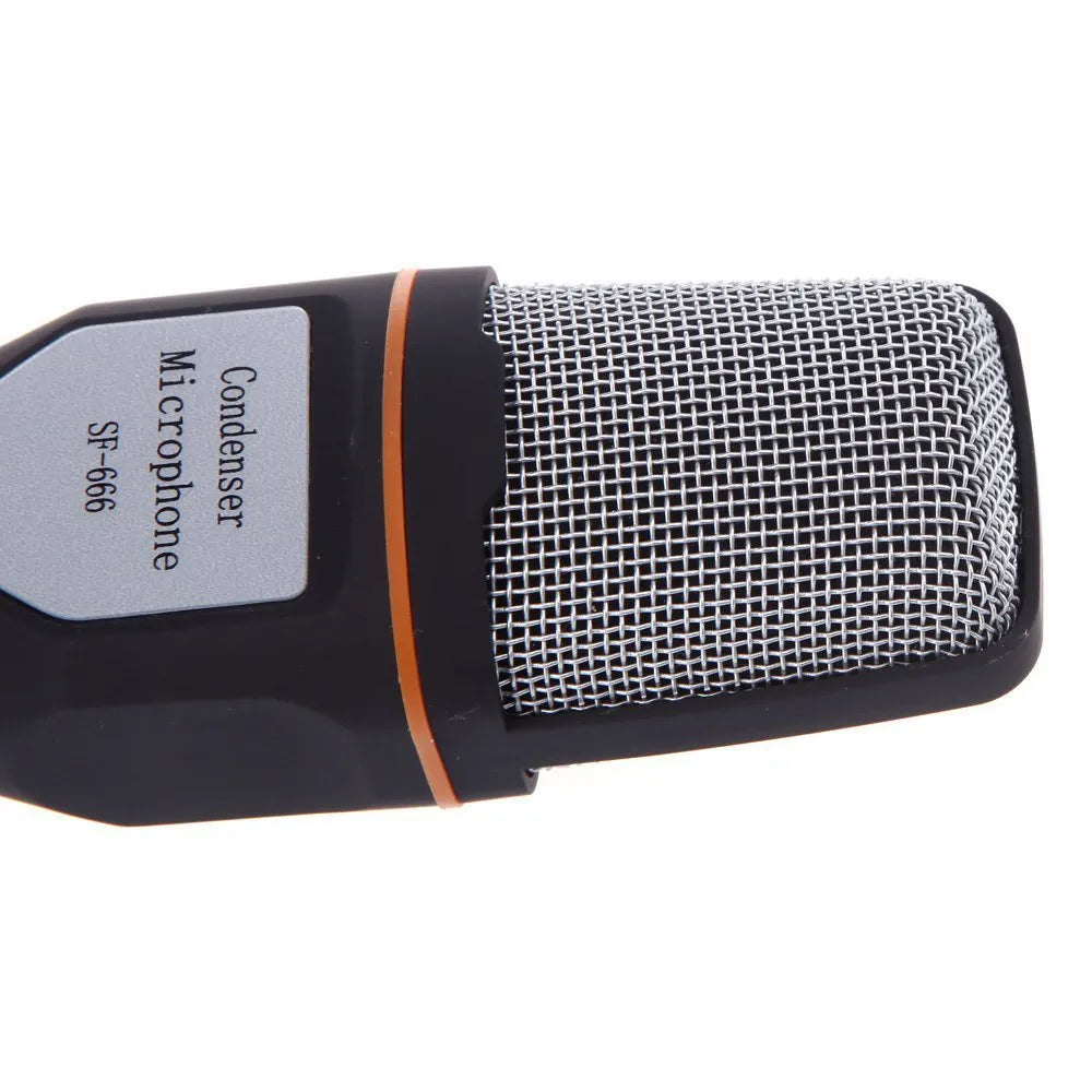 Black wired desktop microphone with a metal holder clip on a desk.