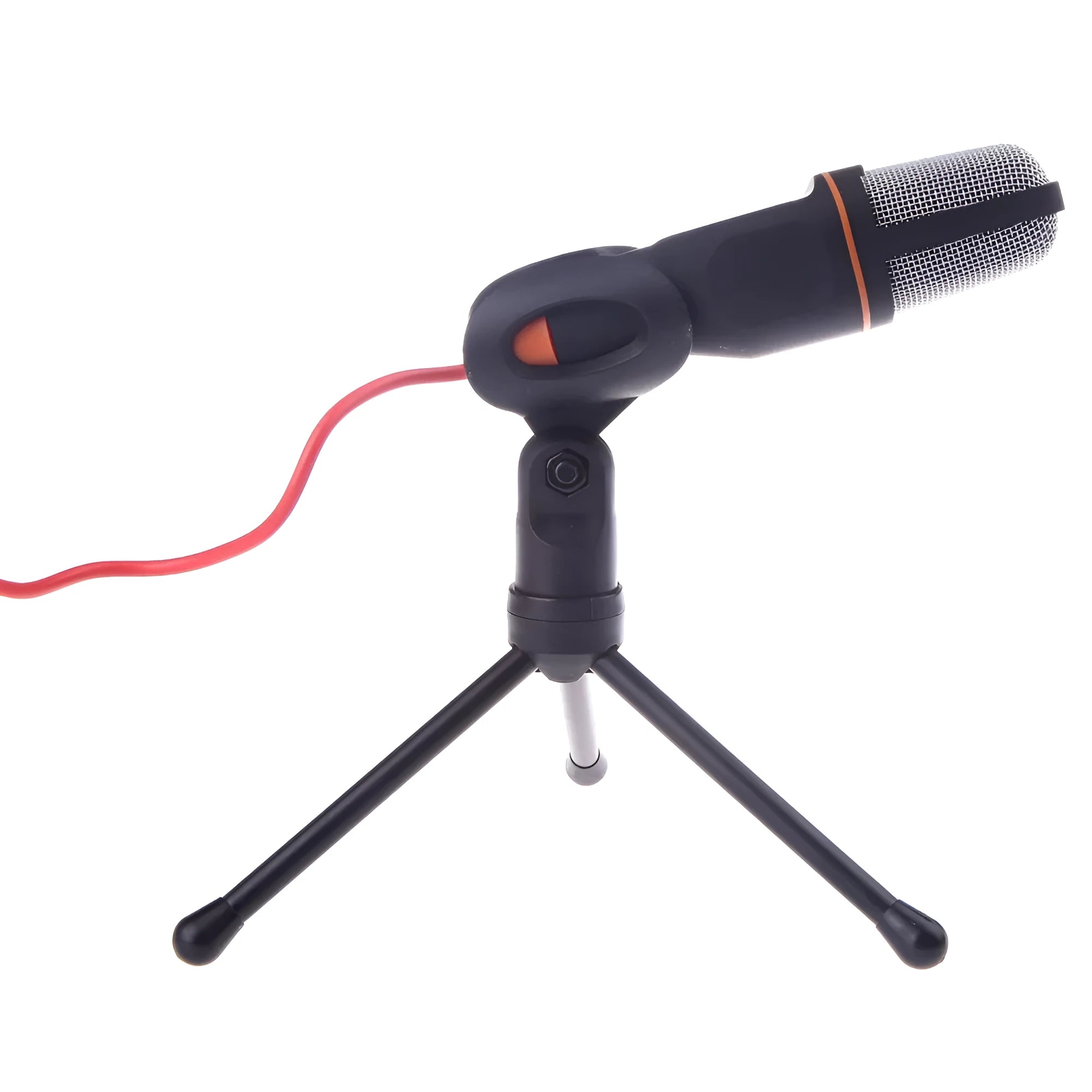 Black wired PC microphone with a clip holder on a desk next to a laptop.