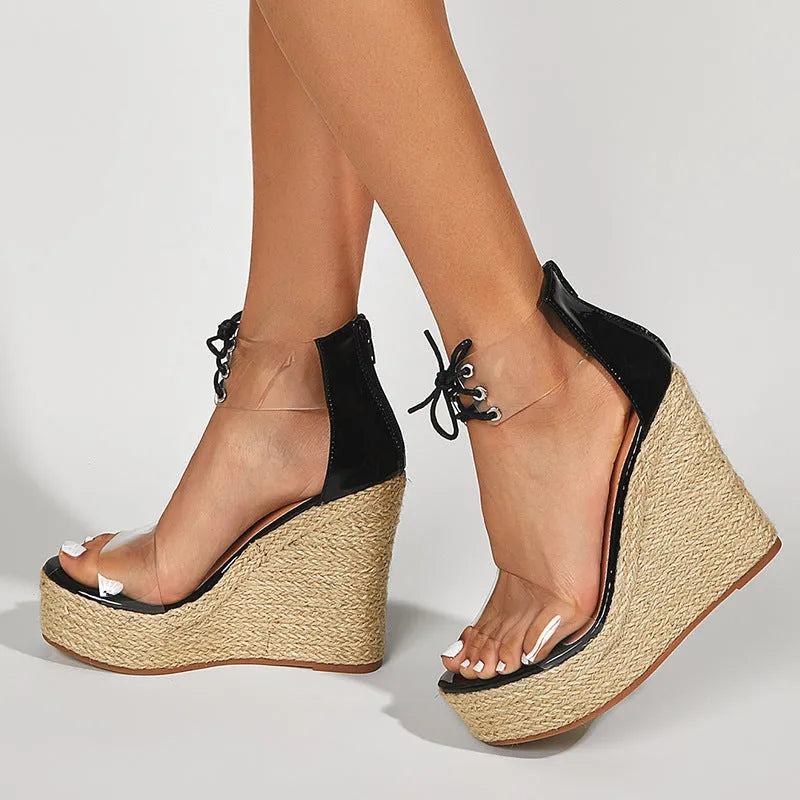 Black women's wedge sandals with hemp rope detail on sole and front tie closure.