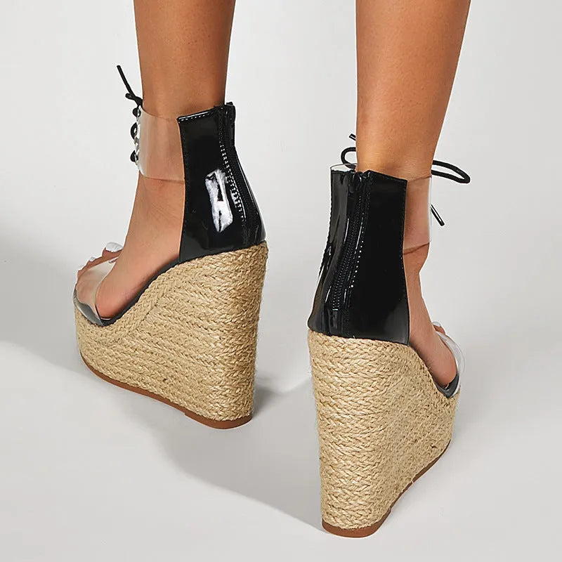 Black women's wedge sandals with hemp rope detail on sole and front tie closure.