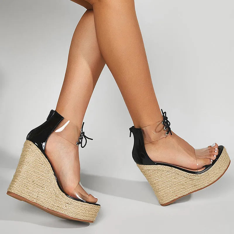 Black women's wedge sandals with hemp rope detail on sole and front tie closure.