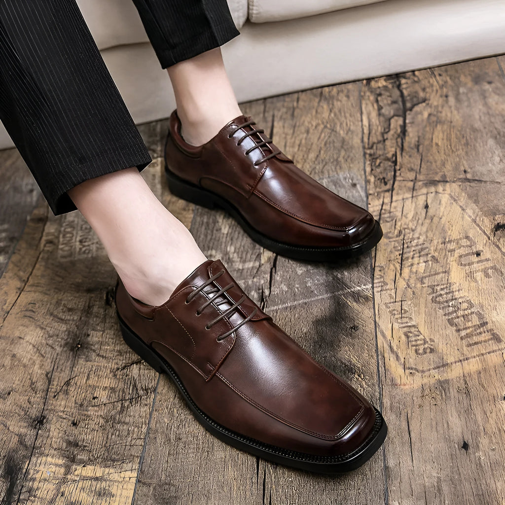 Men's black square toe low-top business casual shoes with a rubber sole.