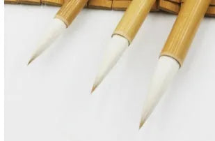 Three pure woolen hair Chinese writing brushes with bamboo handles in large, medium and small sizes