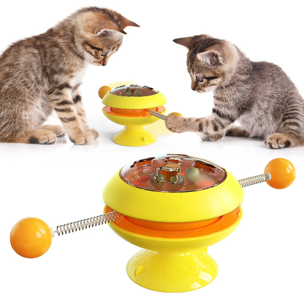 Rotating cat toy with coloured turntable, catnip balls, and suction cup base for interactive indoor play