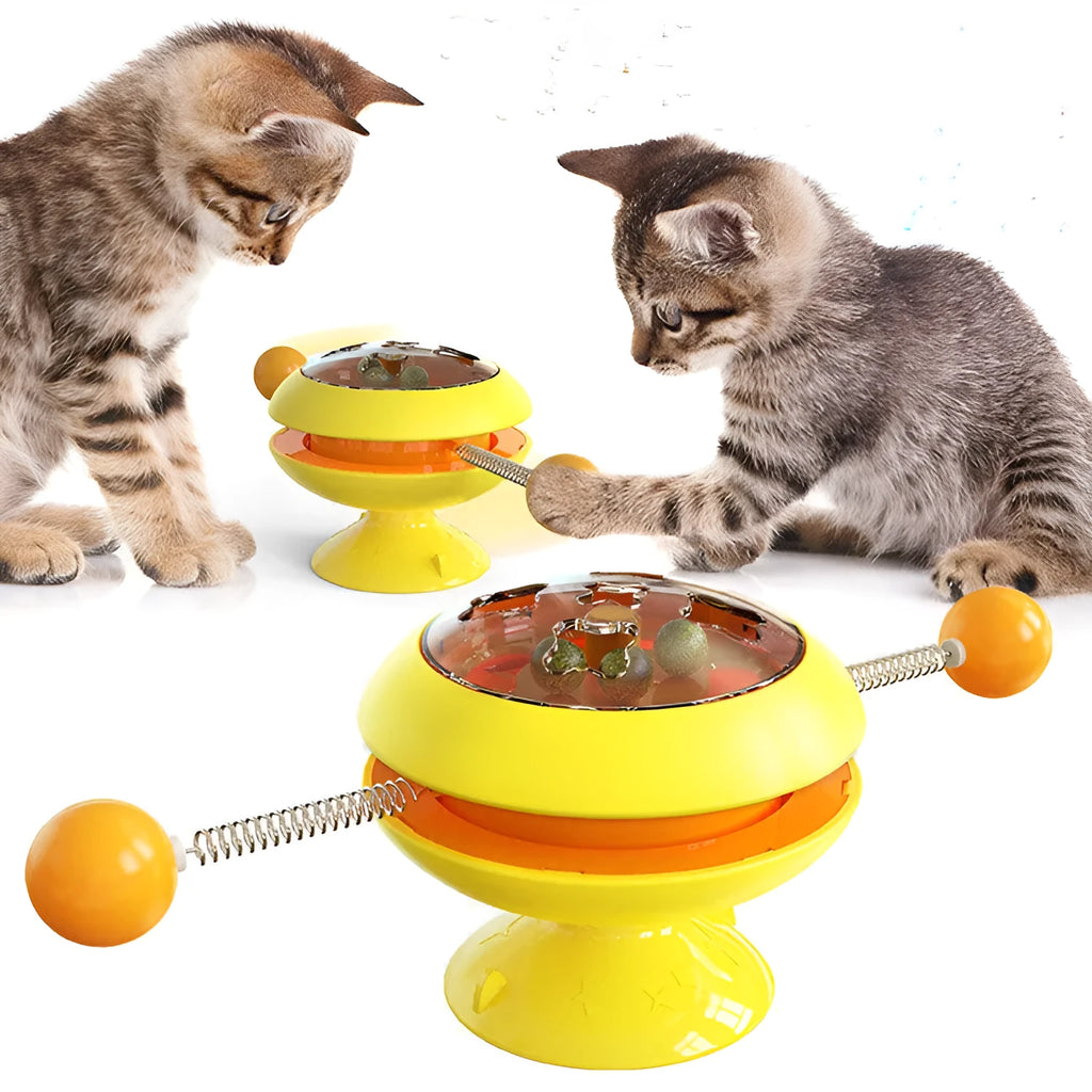 Rotating cat toy with coloured turntable, catnip balls, and suction cup base for interactive indoor play