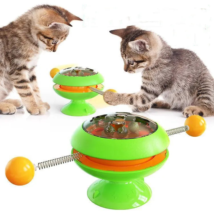 Rotating cat toy with coloured turntable, catnip balls, and suction cup base for interactive indoor play