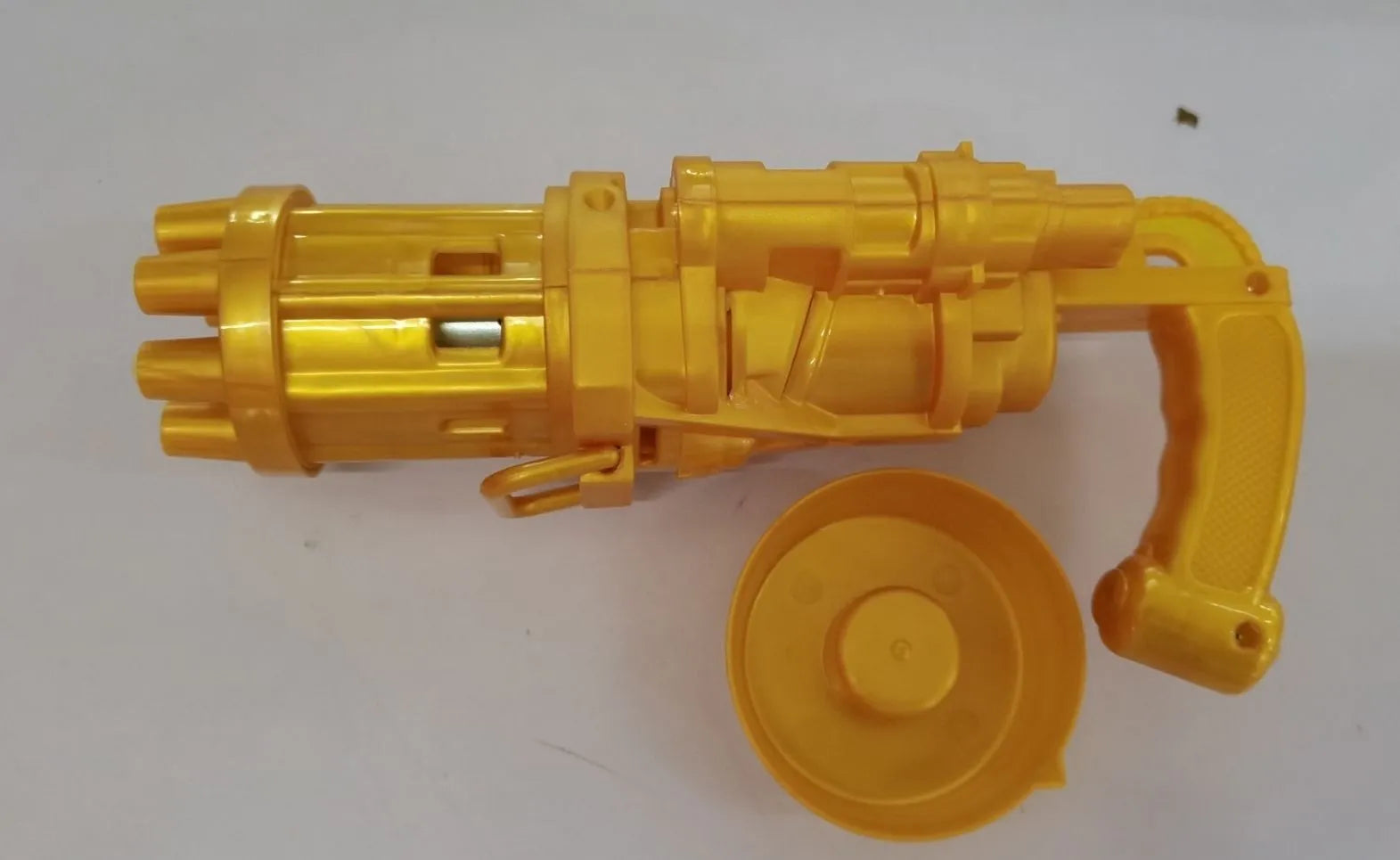 Kids pink bubble machine gun toy with leaf blower design on green grass