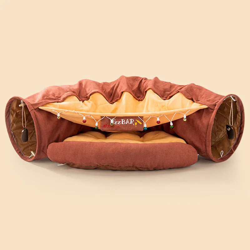 Collapsible cloth cat tunnel in Pink colour with visible opening, measuring 45x50x22 cm, on wooden floor
