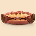 Collapsible cloth cat tunnel in Pink colour with visible opening, measuring 45x50x22 cm, on wooden floor