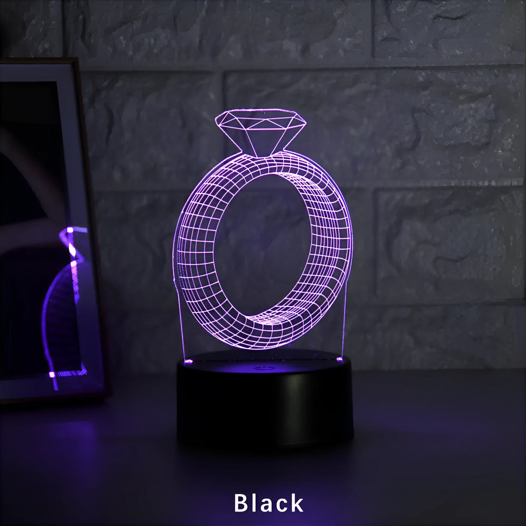 3D LED night light showing a holographic diamond ring design with colour-changing glow on a black base.