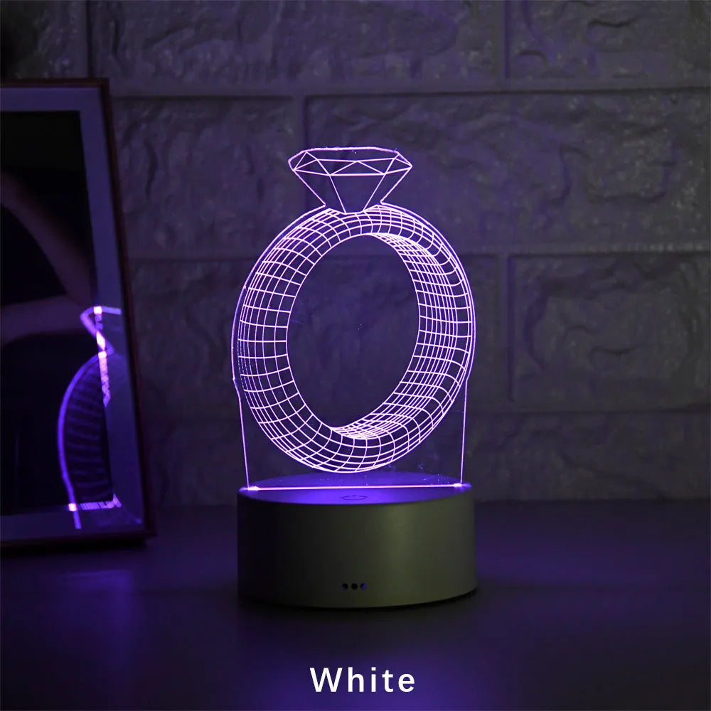 3D LED night light showing a holographic diamond ring design with colour-changing glow on a black base.