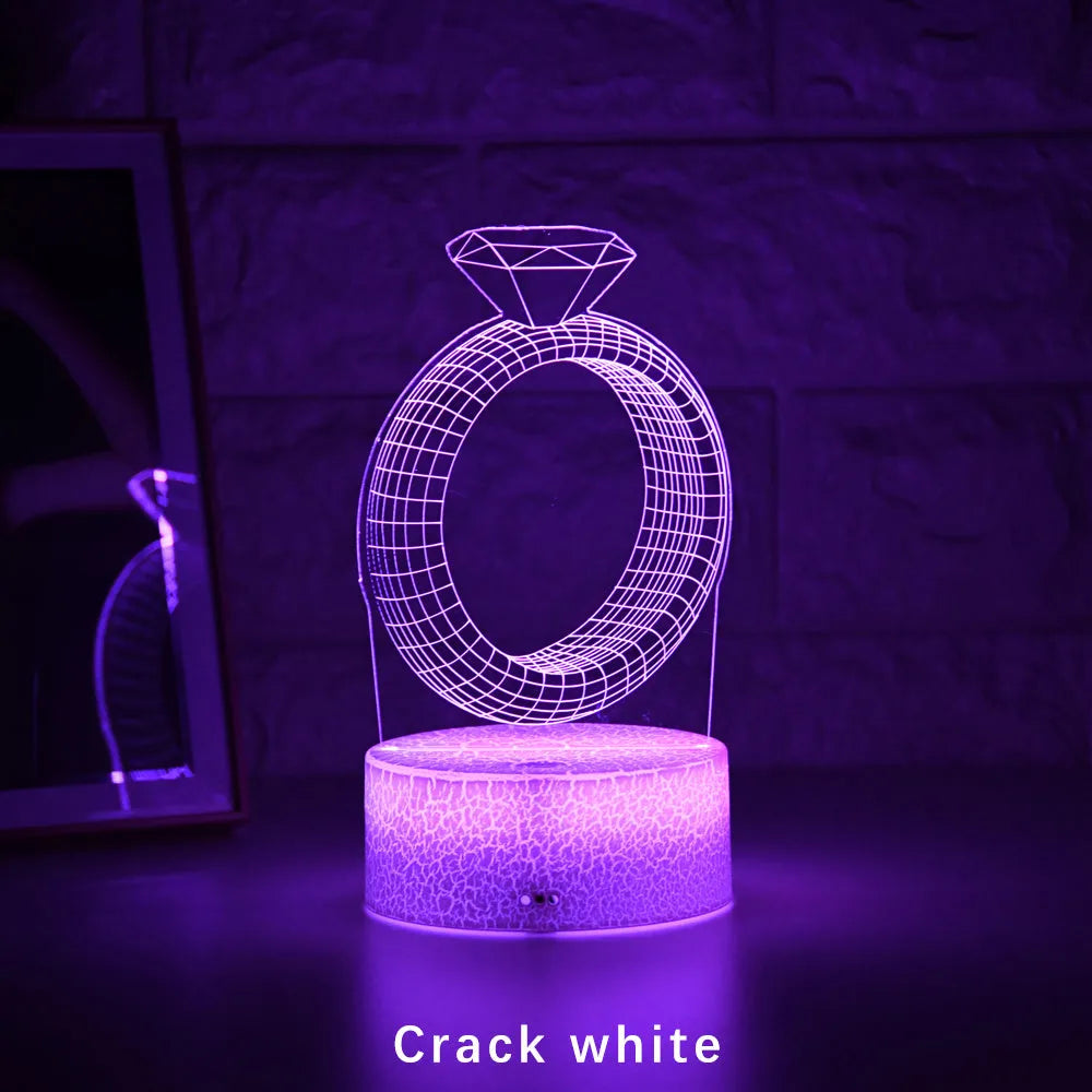 3D LED night light showing a holographic diamond ring design with colour-changing glow on a black base.
