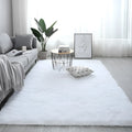 Nordic style plush rectangle carpet with anti-slip backing in a light colour on a wooden floor