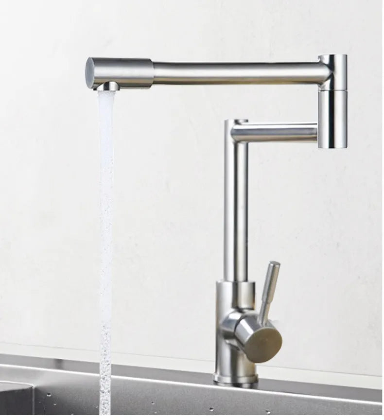 Silver stainless steel kitchen tap with rotating spout and dual hot cold handles