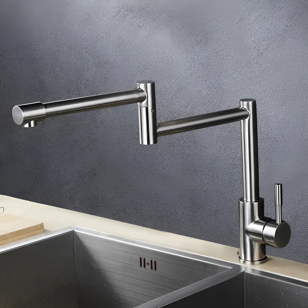 Silver stainless steel kitchen tap with rotating spout and dual hot cold handles