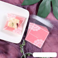 Pink self-adhesive plastic packaging bag with clear window and UV printing, showing 7x7cm dimensions.
