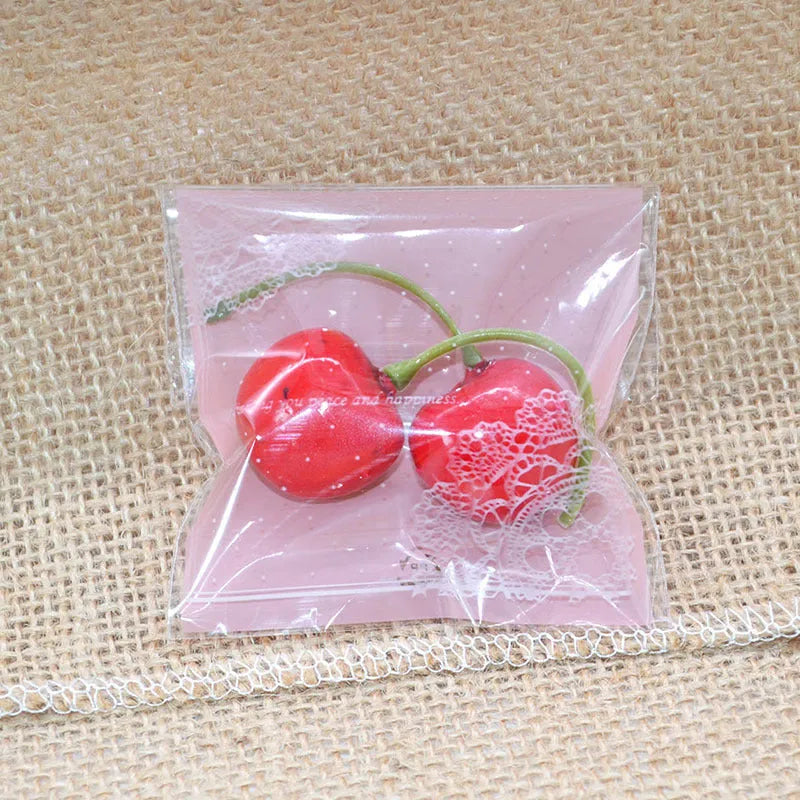 Pink self-adhesive plastic packaging bag with clear window and UV printing, showing 7x7cm dimensions.