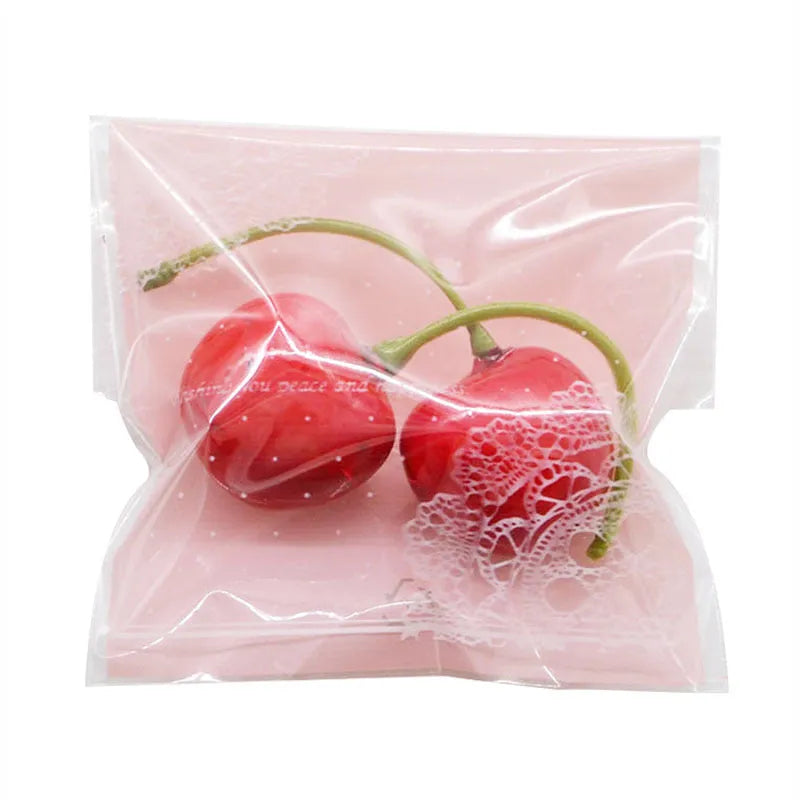 Pink self-adhesive plastic packaging bag with clear window and UV printing, showing 7x7cm dimensions.