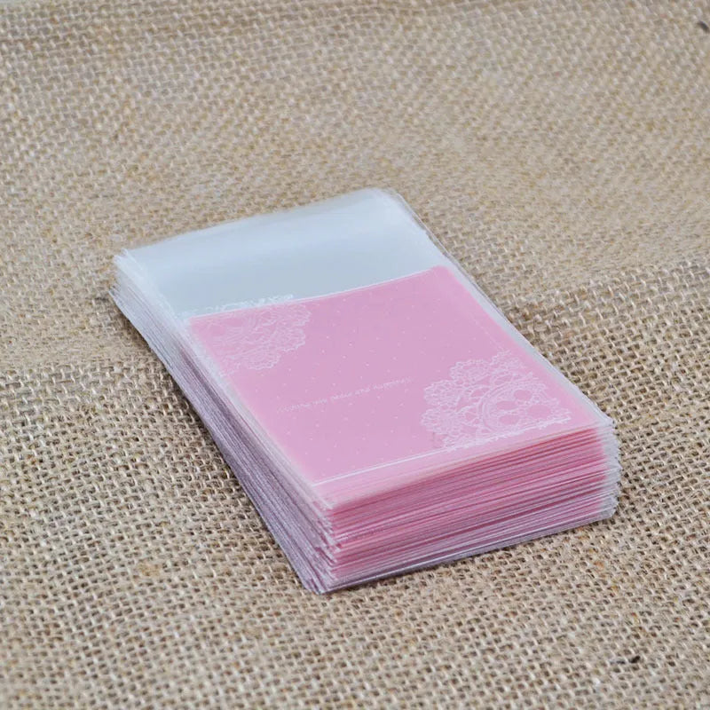 Pink self-adhesive plastic packaging bag with clear window and UV printing, showing 7x7cm dimensions.