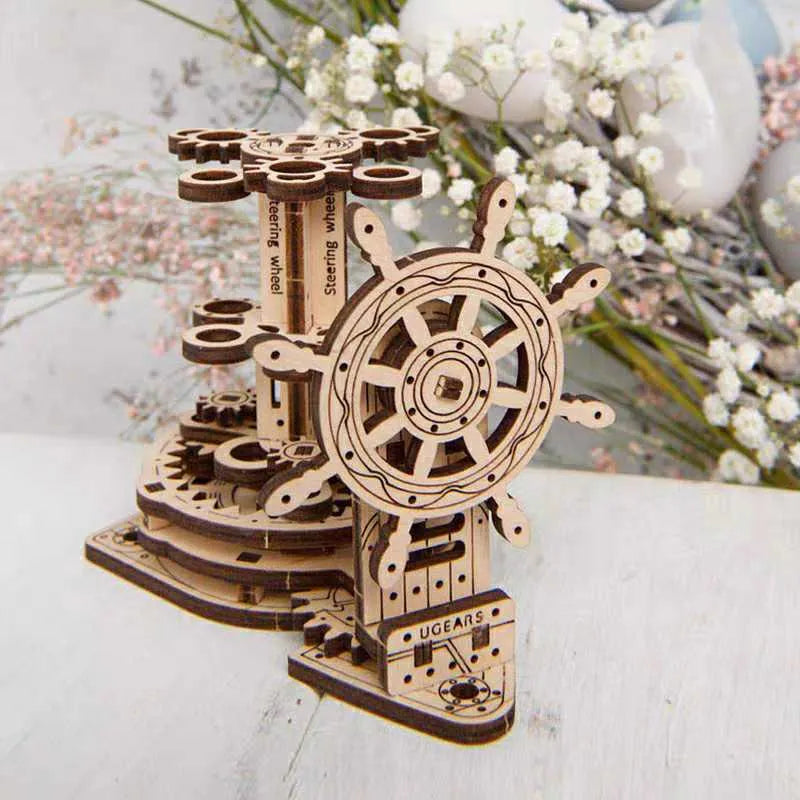 Assembled wooden steering wheel pen holder rotating on a desk with pens.