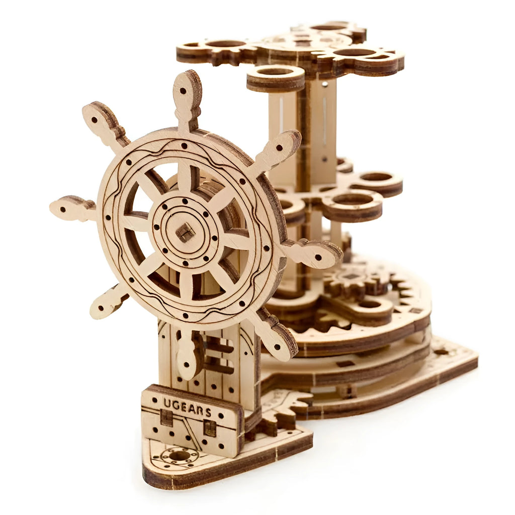 Assembled wooden steering wheel pen holder rotating on a desk with pens.