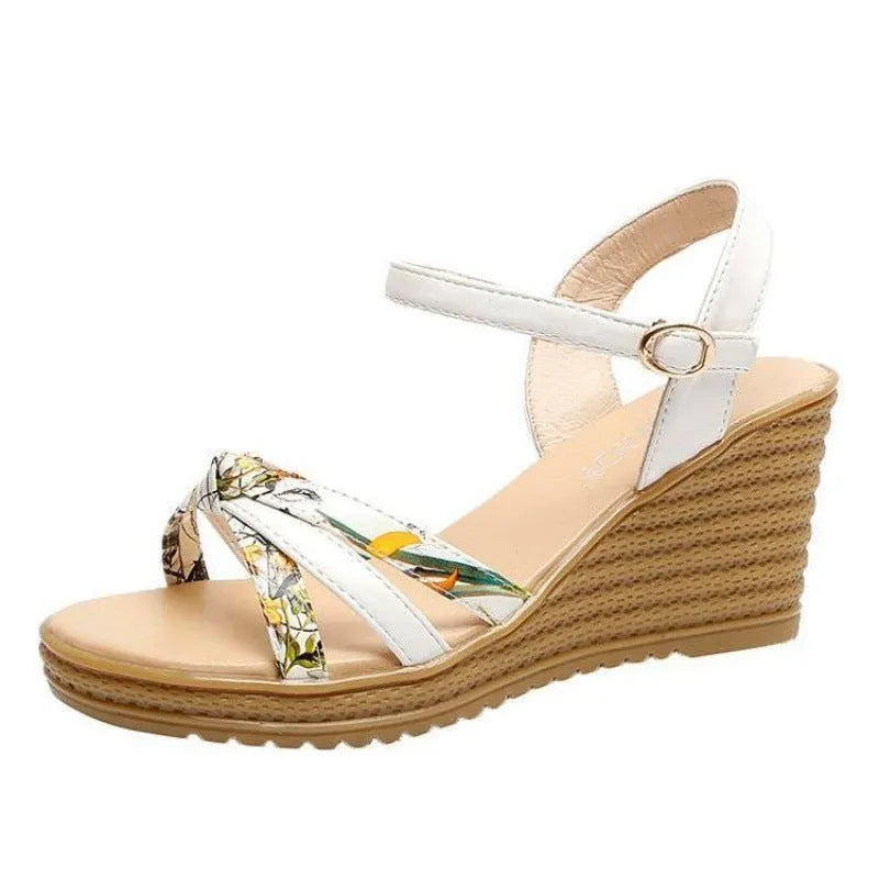 Women's pink wedge sandals with a thick heel, fish mouth design, and a silver buckle closure on a PU sole.