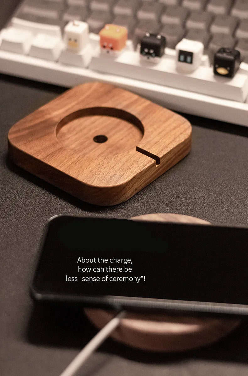 Walnut wood magnetic wireless charging bracket for desktop with phone protective cover.