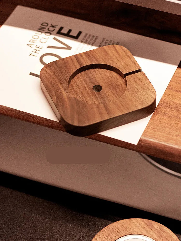 Walnut wood magnetic wireless charging bracket for desktop with phone protective cover.