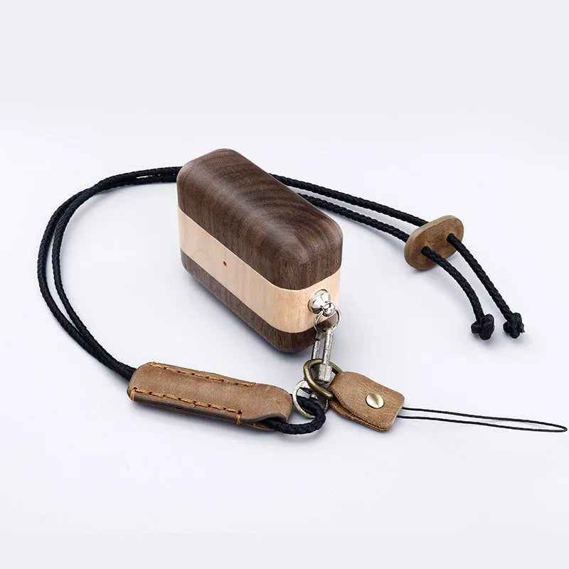 Carved solid wood sleeve for Bluetooth earphones in natural bamboo finish with lanyard loop.