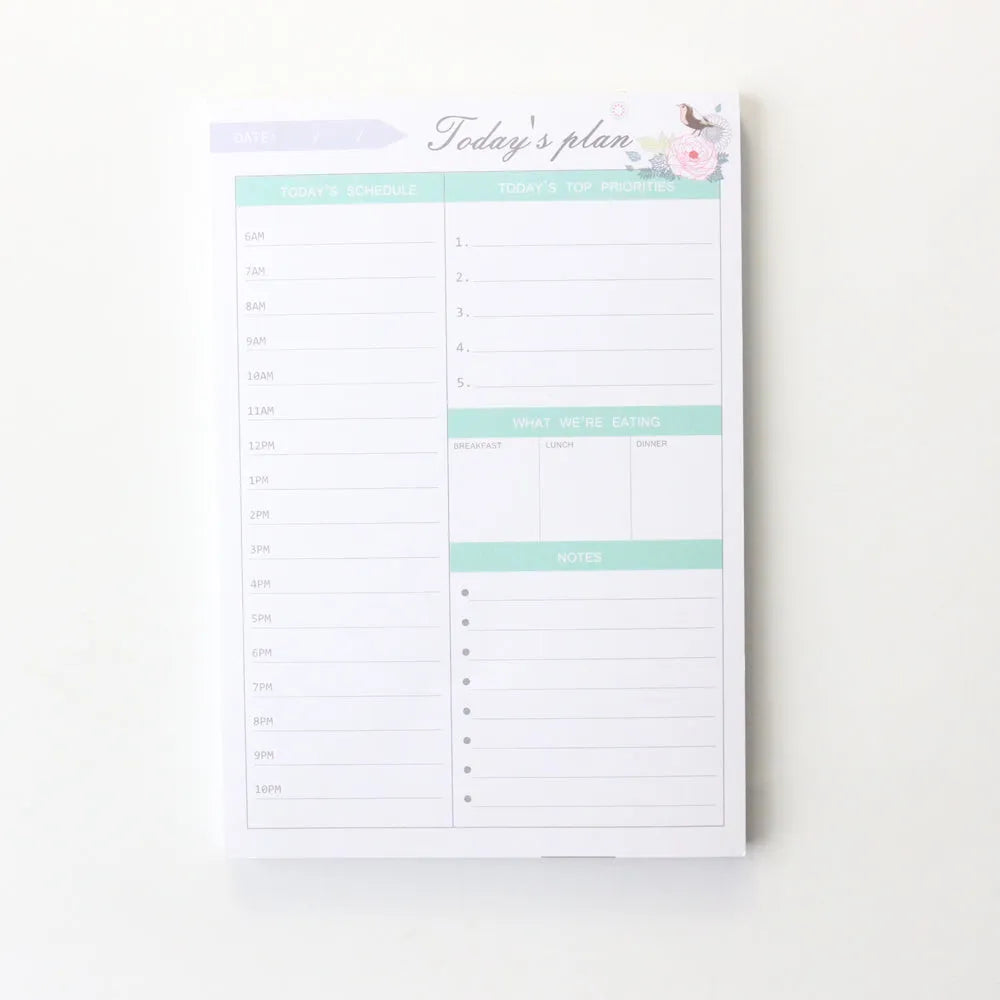 Domikee student desk organiser pad with pink and green planning pages showing weekly and monthly layouts