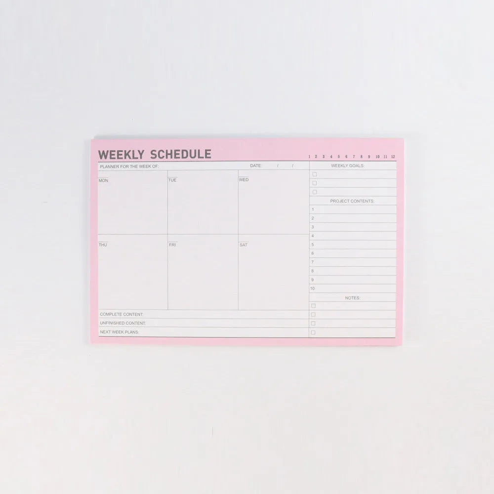 Domikee student desk organiser pad with pink and green planning pages showing weekly and monthly layouts