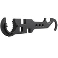 Black steel combination wrench for AR-15 and M4 rifle maintenance on a workshop bench.