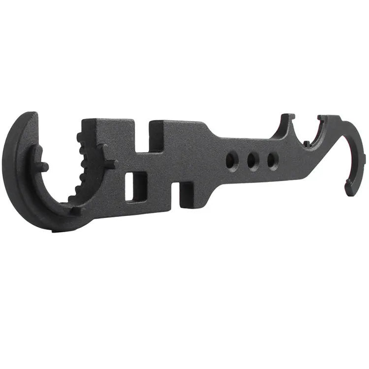 Black steel combination wrench for AR-15 and M4 rifle maintenance on a workshop bench.