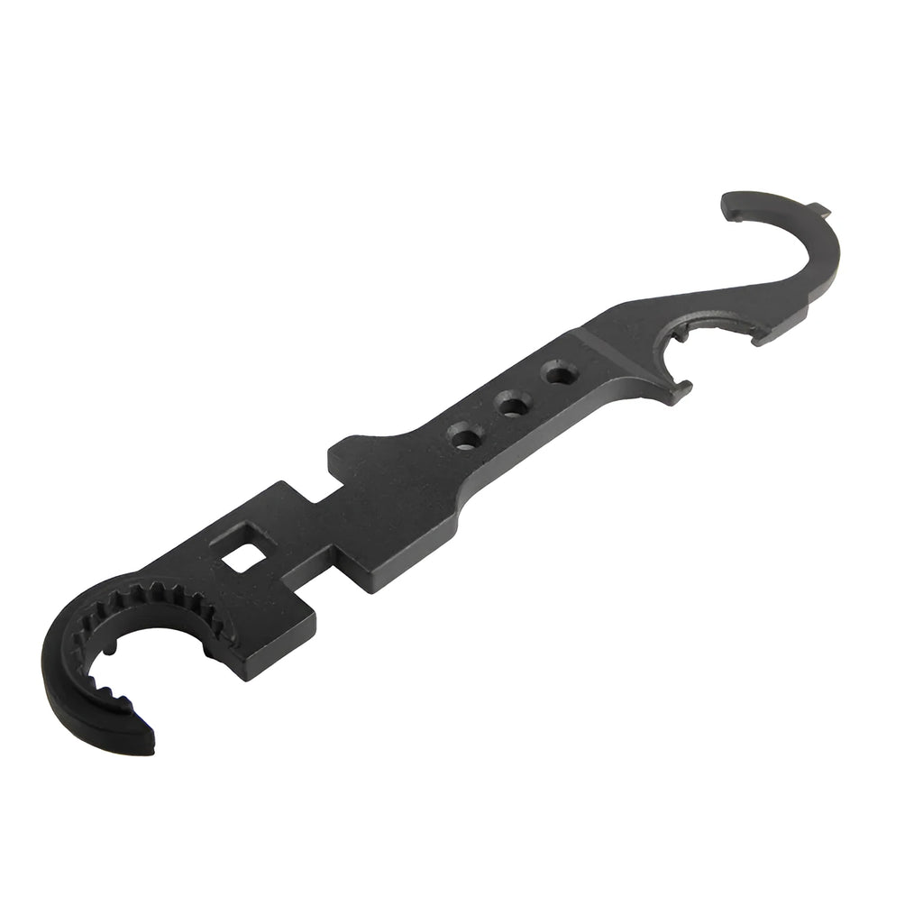 Black steel combination wrench for AR-15 and M4 rifle maintenance on a workshop bench.