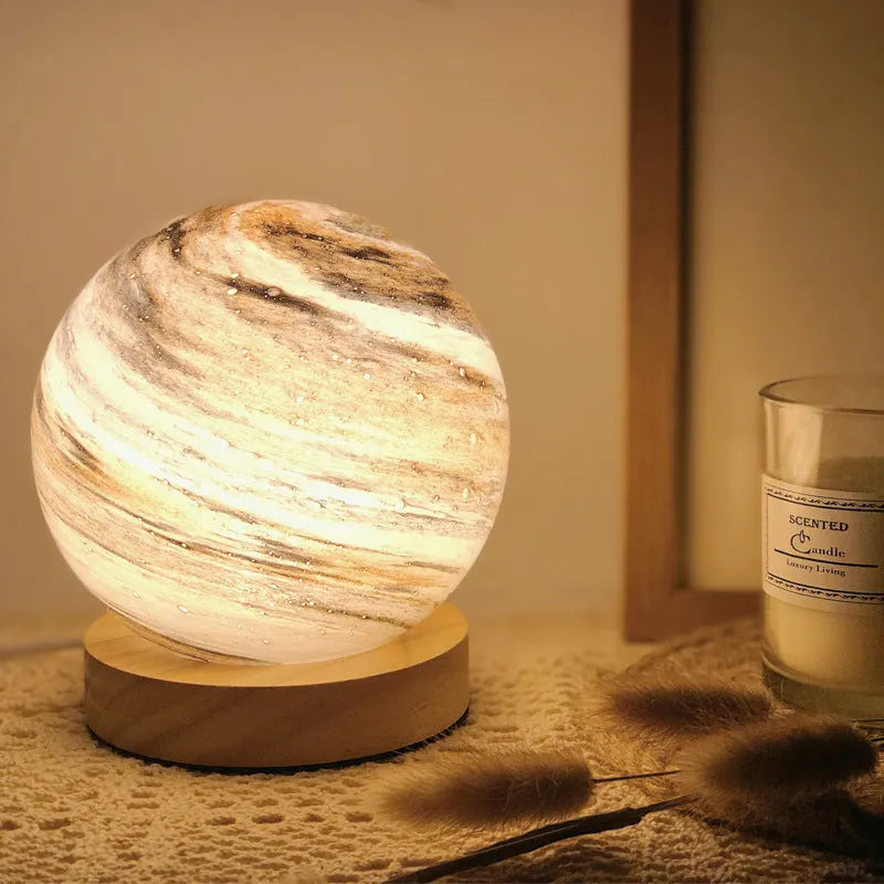 Nordic style Planet Light table lamp with transparent glass shade, shown in emerald green colour.