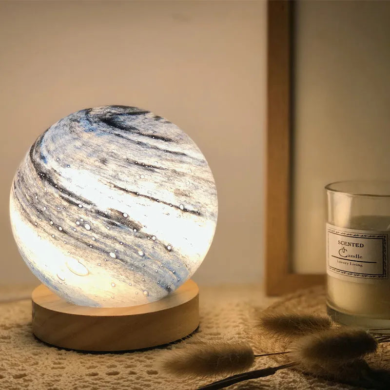 Nordic style Planet Light table lamp with transparent glass shade, shown in emerald green colour.