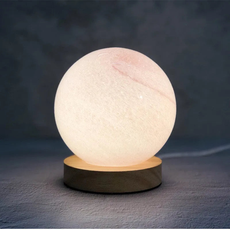 Nordic style Planet Light table lamp with transparent glass shade, shown in emerald green colour.